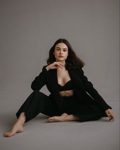 a woman sitting on the floor with her legs crossed