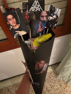 a bunch of pictures are sticking out of a vase