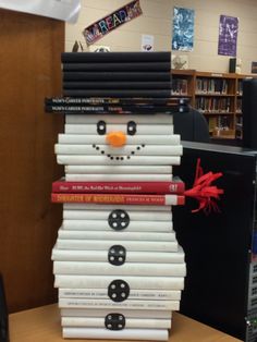 a stack of books with a snowman made out of them