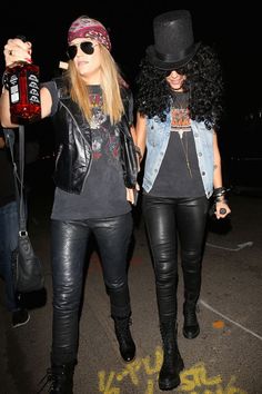 two women in black leather pants and hats