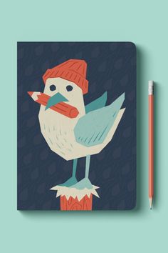 a notebook with a bird wearing a hat and holding a pencil on top of it