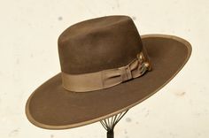 "1940s Wide Brim Western Hat Brown Beaver Fur Felt w/ Wide Rayon Band & Artisan Hat Pin  Chocolate brown beaver wool with wide rayon band & trim. Hat had been stretched to fit a larger head, rayon band had torn away from itself. Pin's had been placed to cover the gap perfectly (: A couple small holes as shown (could have been a part of the original boiling process?) This had is GORGEOUS. Measures 22.5\" around inside height: 4.5\" brim: 4\"" Vintage Flat Bill Felt Hat For Winter, Vintage Flat Bill Hat For Fall, Vintage Fitted Felt Hat For Ranch, Vintage Fur Felt Fedora For Fall, Vintage Brown Felt Hat With Flat Bill, Vintage Fitted Felt Hat With Flat Bill, Vintage Brown Flat Bill Felt Hat, Vintage Fitted Fedora For Ranch, Fitted Vintage Fedora For Ranch