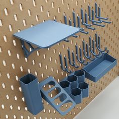 there are several blue objects on the wall next to each other, including cups and utensils