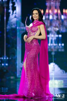 a woman in a pink dress posing for the camera