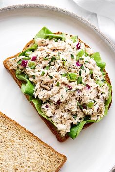 a white plate topped with a sandwich covered in chicken salad