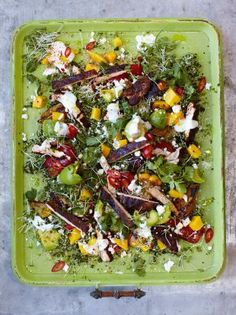 a green tray filled with lots of food