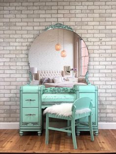 a room with a brick wall and a green dresser, mirror and chair in front of it