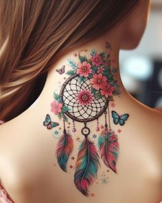 the back of a woman's neck is decorated with colorful flowers and feathers, which are