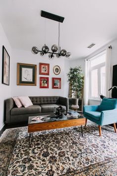 a living room filled with furniture and pictures on the wall