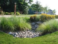 a garden with rocks and grass in the middle