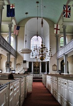 the interior of a church with white cabinets and an american flag hanging from the ceiling