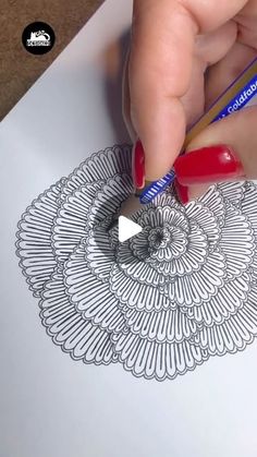 someone is drawing on paper with a pencil