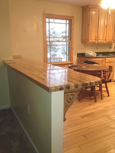 a kitchen with wooden floors and an island