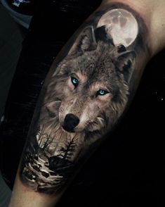 a man's arm with a wolf tattoo on it and the moon in the background