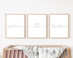 three prints on the wall above a crib