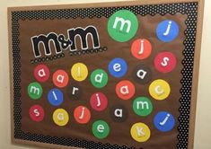 a bulletin board with letters and numbers in the shape of m & m on it