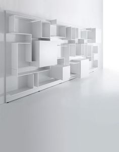 a white book shelf with several shelves on each side and one section missing from the wall