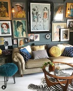 a living room filled with furniture and pictures on the wall