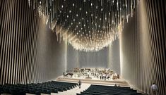 an auditorium with rows of seats and lights hanging from the ceiling