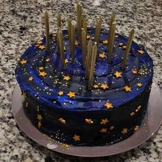 there is a blue cake with gold stars on it