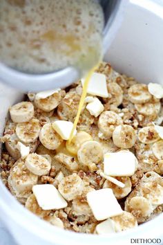 a bowl filled with oatmeal and bananas being poured into it