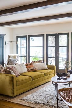 a living room filled with furniture and lots of windows