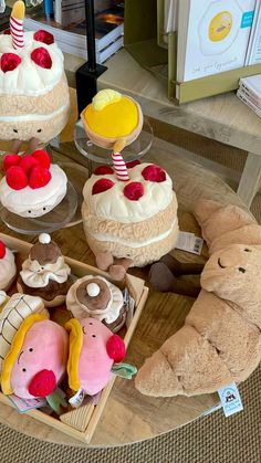 there are many cakes on the table with teddy bears and other items around them that look like they have been made out of cake