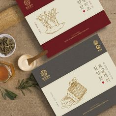 two packets of tea sitting on top of a table next to some spices and herbs