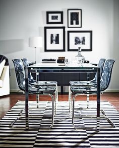 a black and white striped rug in front of a dining room table with four chairs