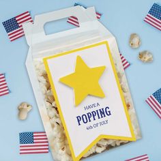 a bag of popcorn with a yellow star on it and some american flags around it