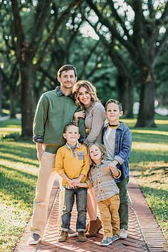 a family posing for a photo in the park