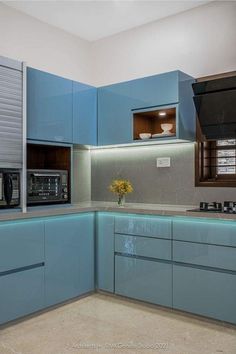 a kitchen with blue cabinets and counter tops