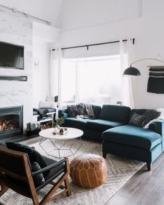 a living room filled with furniture and a flat screen tv mounted on the wall above a fireplace