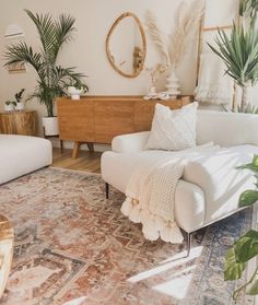 a living room filled with furniture and plants