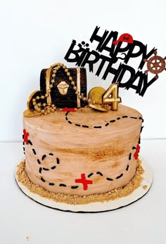 a birthday cake with the number four on it and an image of a pirate's chest