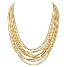 Wrap yourself in the luxurious beauty of the Marco Bicego Cairo 9- Strand necklace, a masterpiece of Italian craftsmanship. Made from rich 18 karat yellow gold, this striking necklace features nine delicate serpentine strands that gracefully coil around the neck, creating a layered look of effortless elegance. Each strand is meticulously hand-twisted, showcasing Marco Bicego’s signature artisanal techniques and attention to detail. The soft, radiant glow of the yellow gold gives this piece a timeless allure, making it a stunning accessory for any occasion. Designed to drape beautifully and comfortably, the necklace offers both versatility and sophistication. Whether worn with a sleek evening gown or as a bold accent to everyday attire, this necklace brings a touch of modern luxury to any l Marco Bicego Necklace, Marco Bicego Jewelry, Marco Bicego, Gold Bead Necklace, Blue Topaz Earrings, Topaz Earrings, Modern Necklaces, Multi Strand Necklace, Exquisite Jewelry