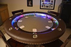 a round table with several lights on it in the middle of a living room area