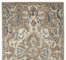 a rug with an ornate design on the front and back side, in grey tones