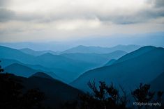 the blue mountains are covered in dark clouds