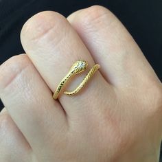 Simple textured snake ring is made of 925 Sterling Silver. Gold color is 18K plated. Eyes are set with Green color CZ stones. Ring is open at the front and can be adjusted from size 6-9. Ships in a gift box. Adjustable Gold Snake Ring, Adjustable Snake Ring In Yellow Gold, Adjustable Yellow Gold Snake-shaped Ring, Adjustable Snake Ring Gift, Gold Snake Ring As Gift, Adjustable Snake Shape Promise Ring, Gold Snake Ring, Bvlgari Jewelry Set, Tentacles Ring