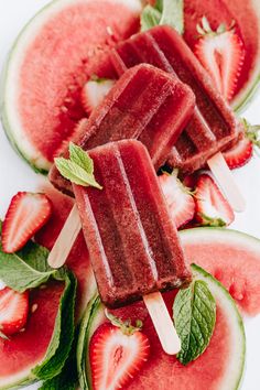 watermelon popsicles with mint leaves and sliced strawberries