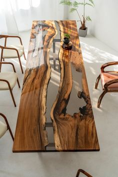 a table made out of wood and glass with a plant in the center on top