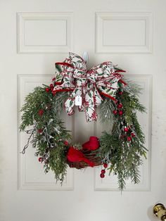 a christmas wreath hanging on the front door