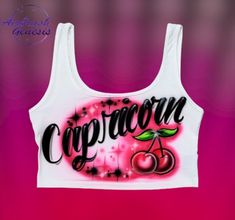 a white crop top with the words capricone written in black ink on it