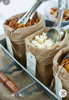 there are several bags of food on the table with spoons in them and plates