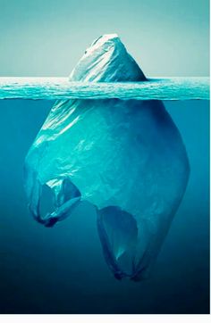 an iceberg floating in the water with a plastic bag on it's side