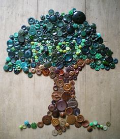 a tree made out of buttons on a wooden floor