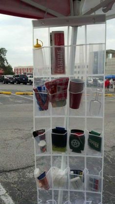 a plastic cup holder with cups hanging from it's sides on a parking lot