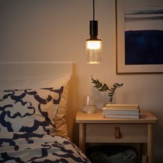 a lamp that is on above a bed