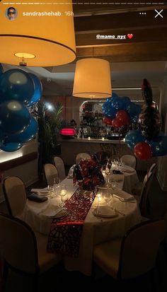 an image of a party setting with balloons in the air and table set for two